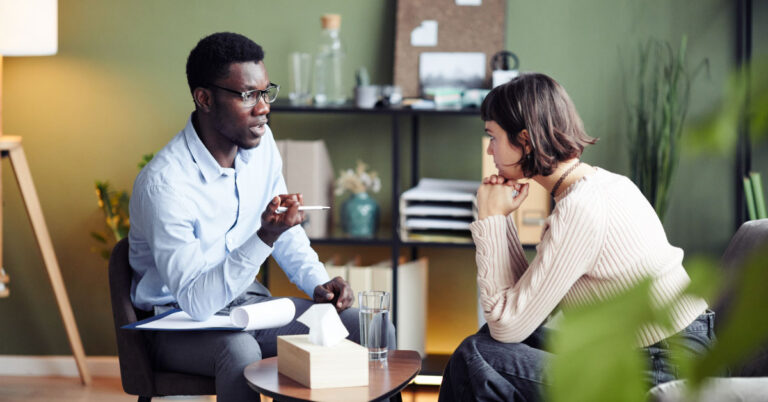Therapist and patient speaking during a session at the therapist's office.