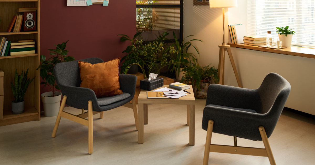 Calm therapist's office with a seating area and comfortable lighting.